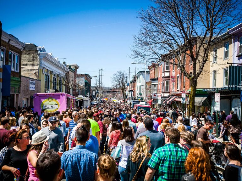 crowded streat at food event with trucks on sides